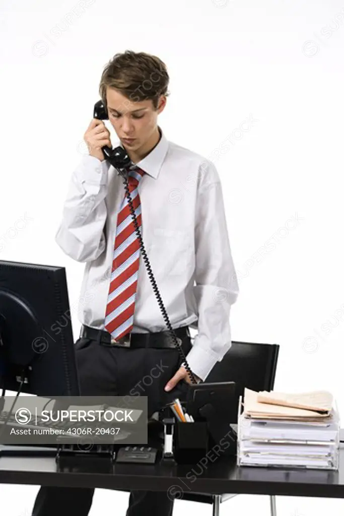 A teenage boy as a businessman at the office.