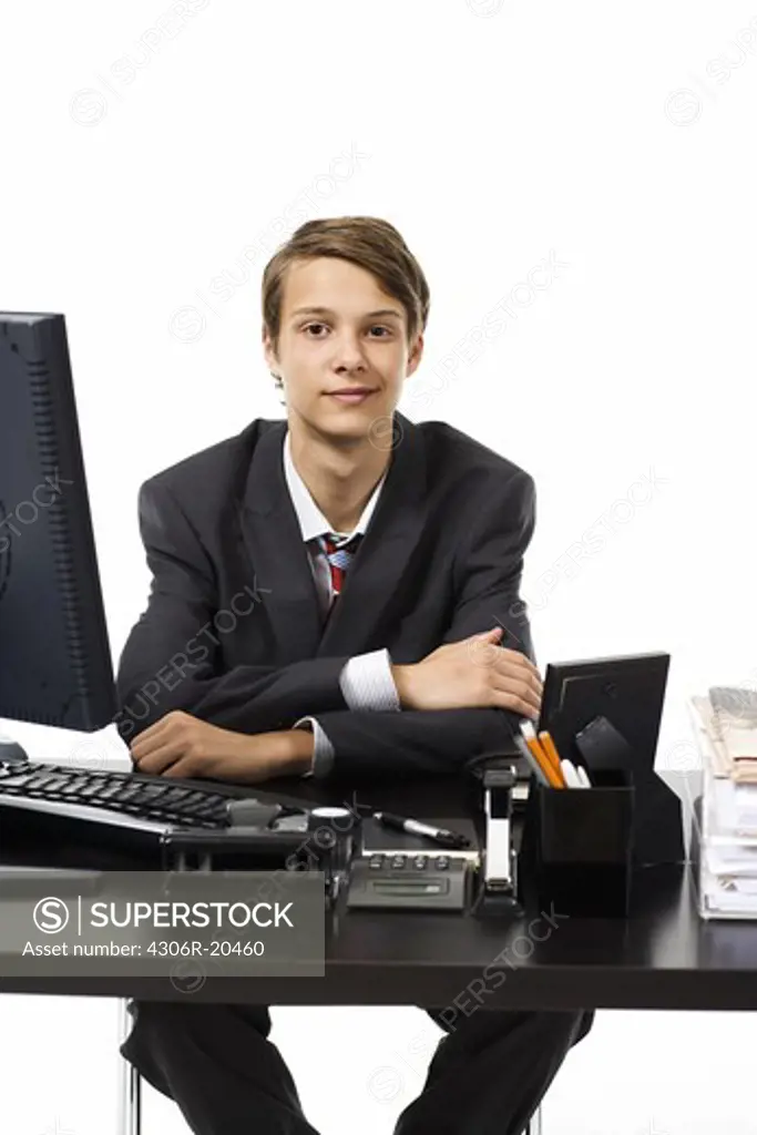 A young boy as a businessman at the office.