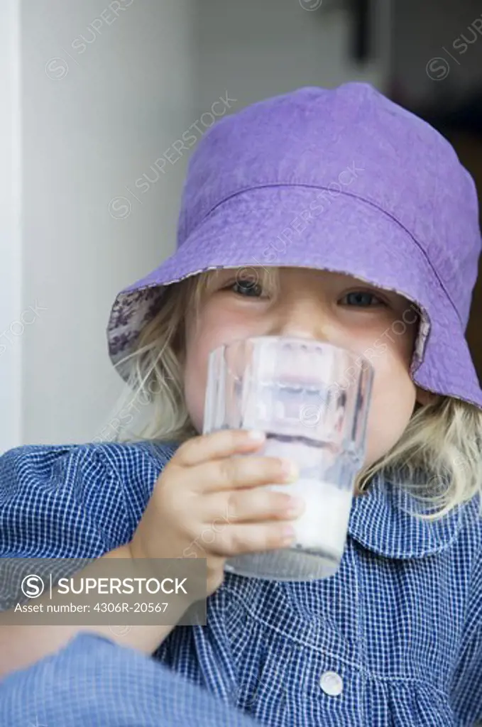 Girl drinking milk, Sweden.