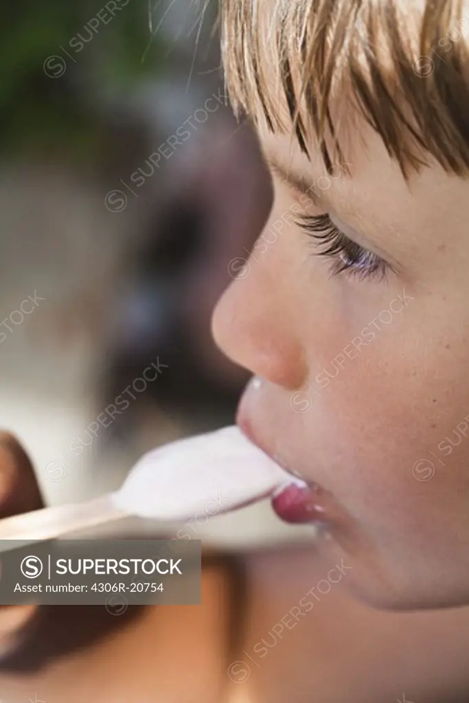 Profile of boy eating ice cream