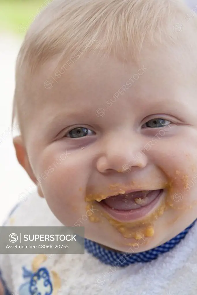 Close up of baby with dirty face after eating
