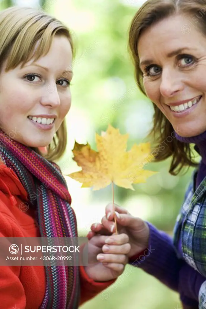 Mother, daughter and autumn leaf, Sweden.