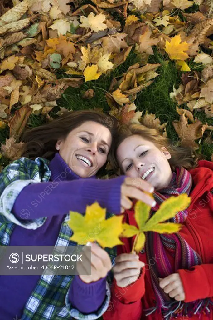 Mother, daughter and autumn leaves, Sweden.