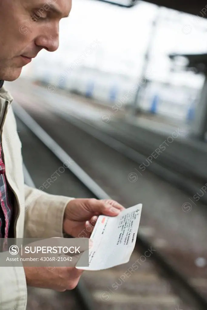 A man at a platform of a railway station, Sweden.