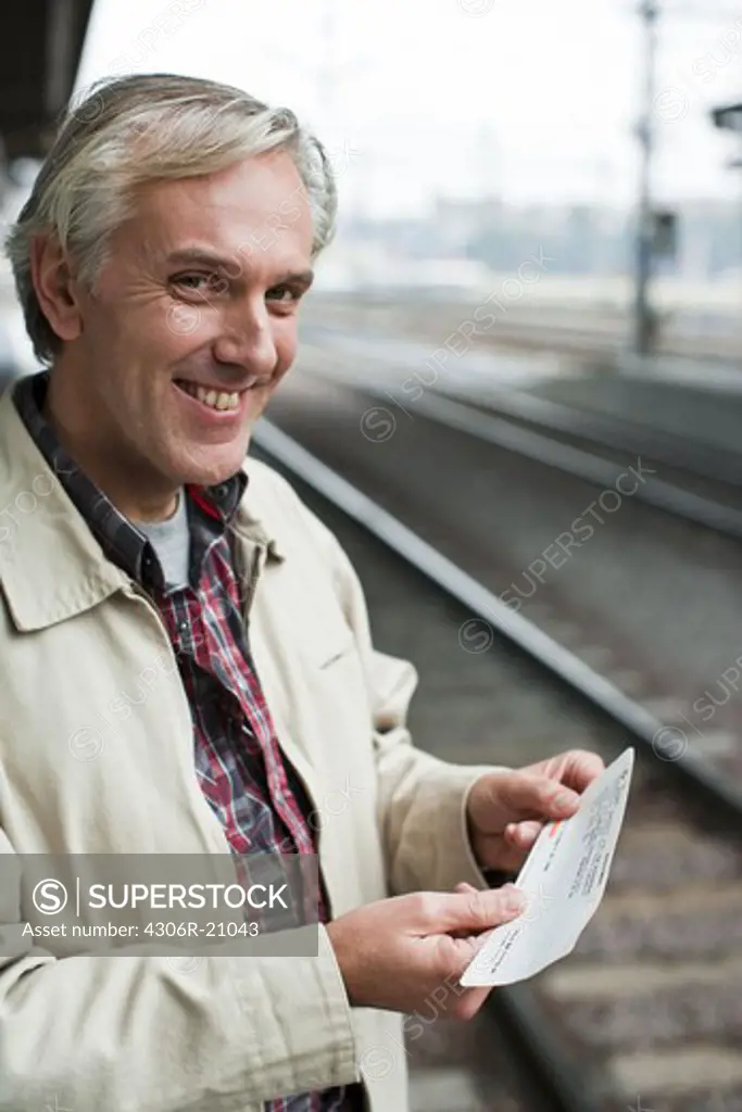 A man at a platform of a railway station, Sweden.