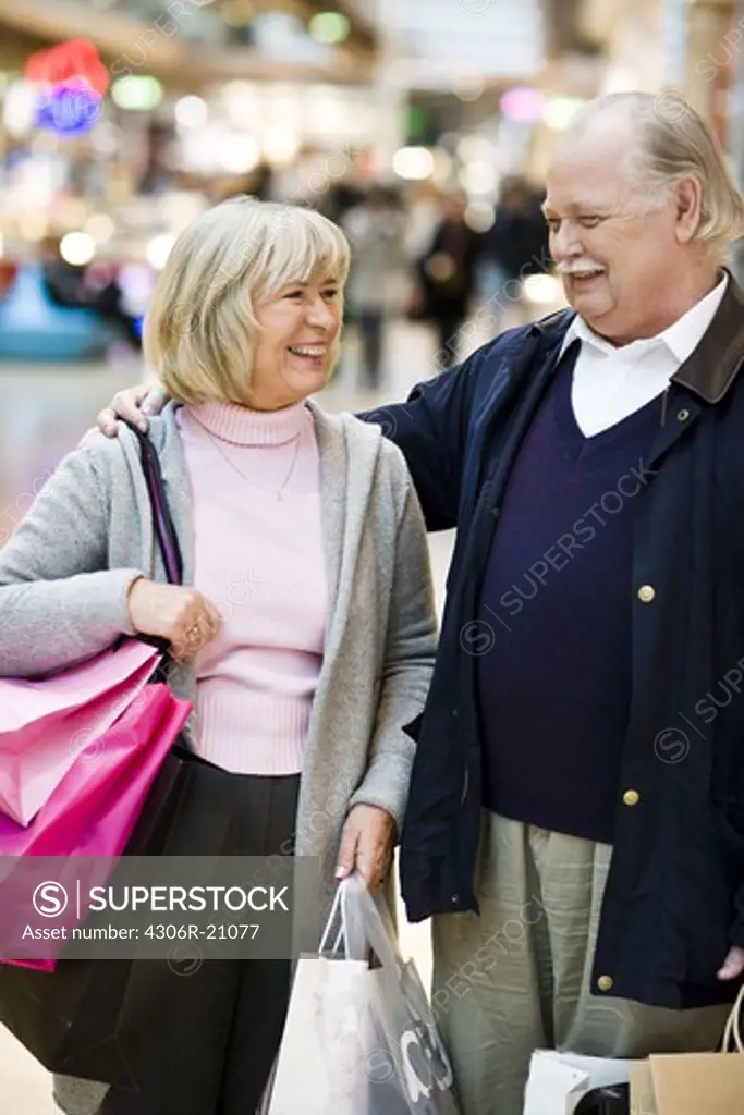 Senior couple carrying shopping bags, Stockholm, Sweden.