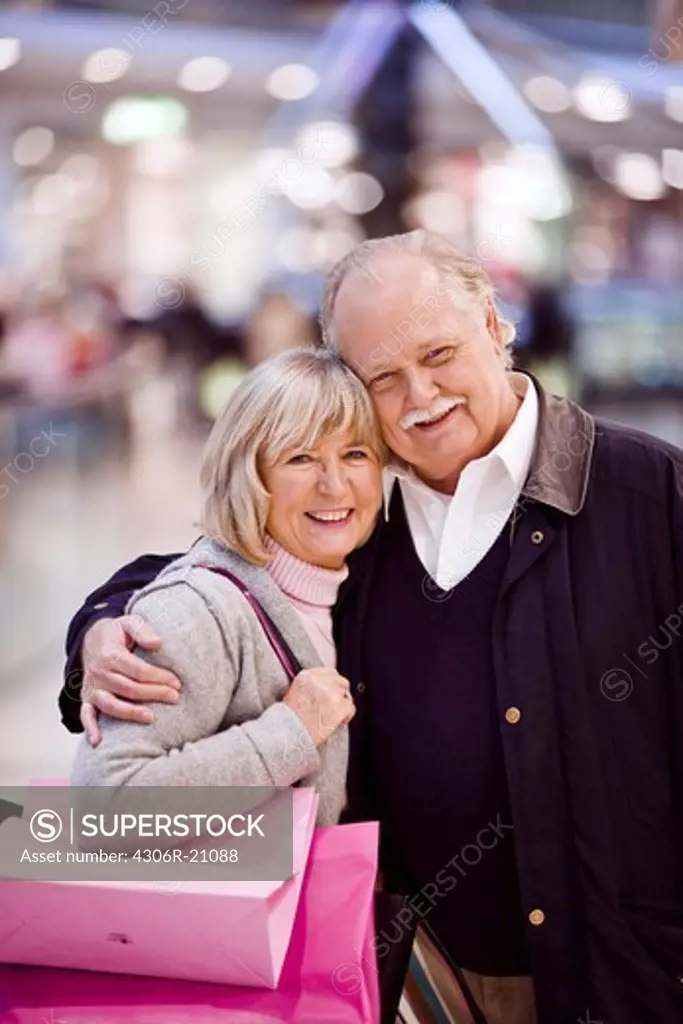 Senior couple carrying shopping bags, Stockholm, Sweden.