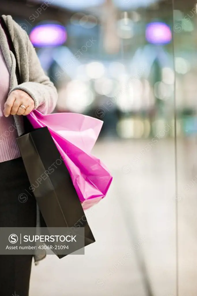 A woman carrying shopping bags, Stockholm, Sweden.
