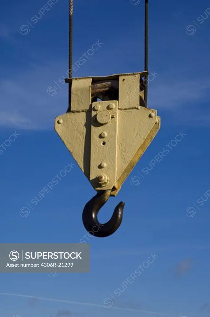 A hook from a lifting crane against a blue sky, Sweden.