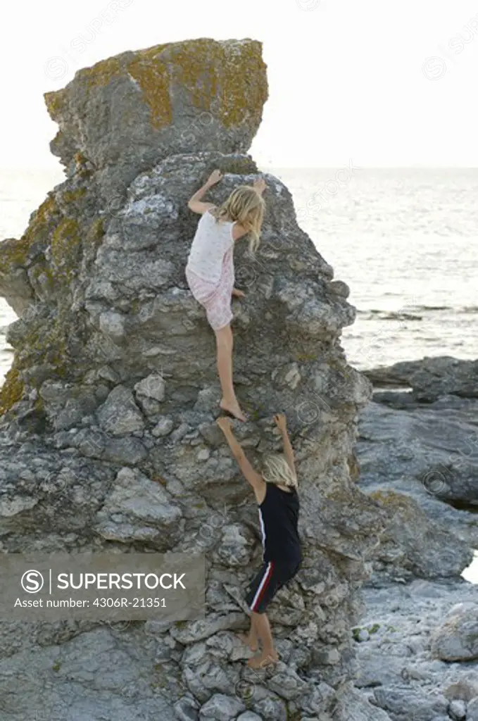 Children climbing rock