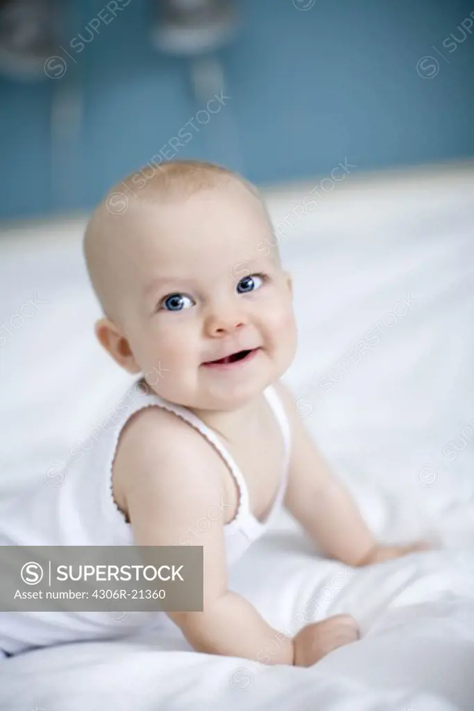 Portrait of a baby lying in a bed, Sweden.
