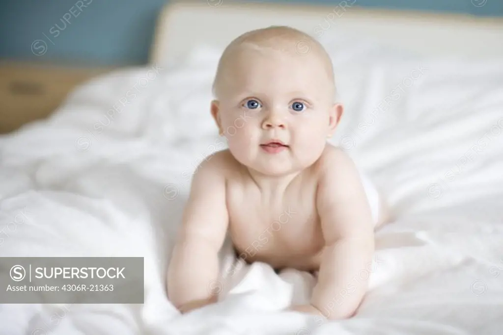 Portrait of a baby lying in a bed, Sweden.