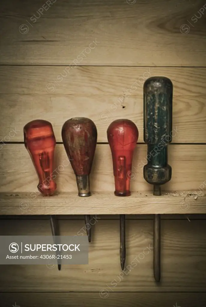 Various screwdrivers in wooden rack