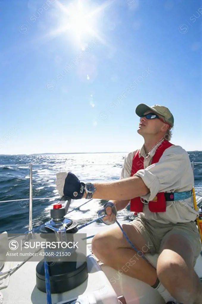 Man on a sailing-boat at sea, the Baltic Sea.