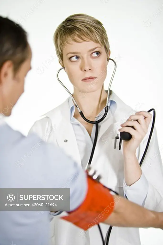 A female doctor using a blood-pressure gauge, Sweden.