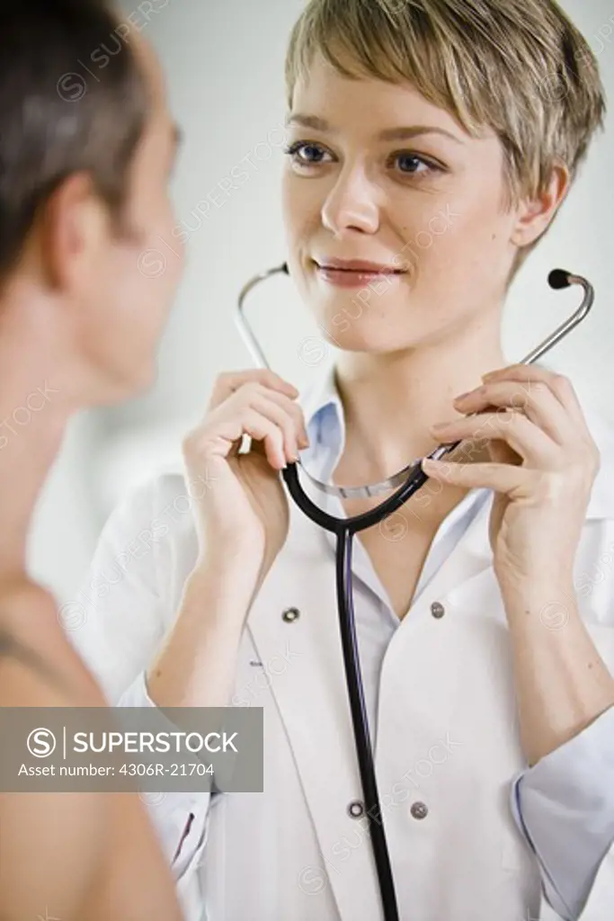 A doctor using a stethoscope at a patient, Sweden.
