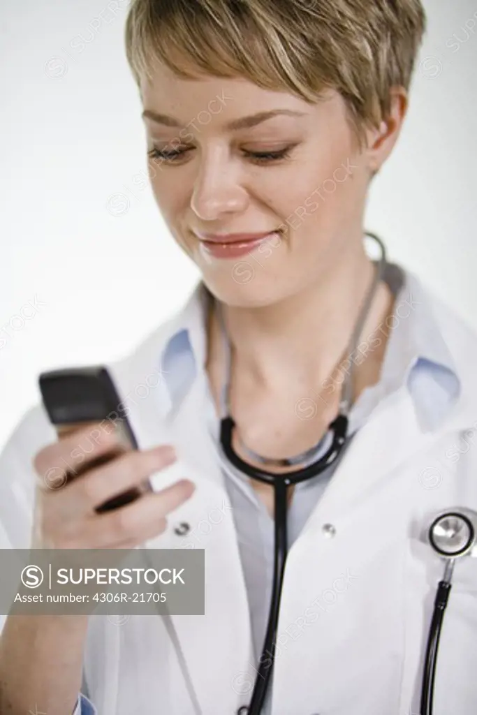 A female doctor using a mobile phone, Sweden.