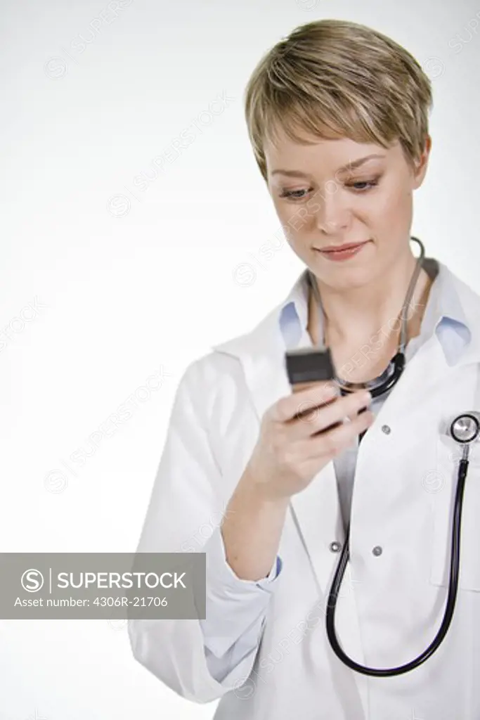 A female doctor using a mobile phone, Sweden.