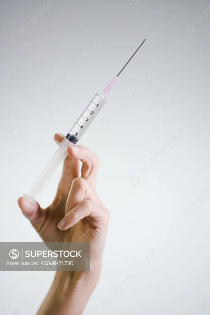 Nurse injecting, close-up.