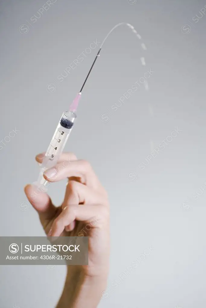 Nurse injecting, close-up.