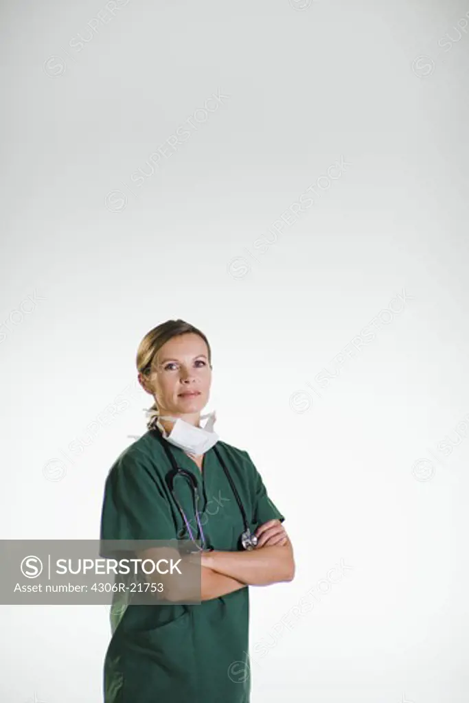 A doctor wearing a green uniform.