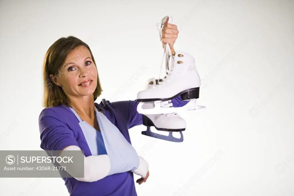 An injured woman holding skates.