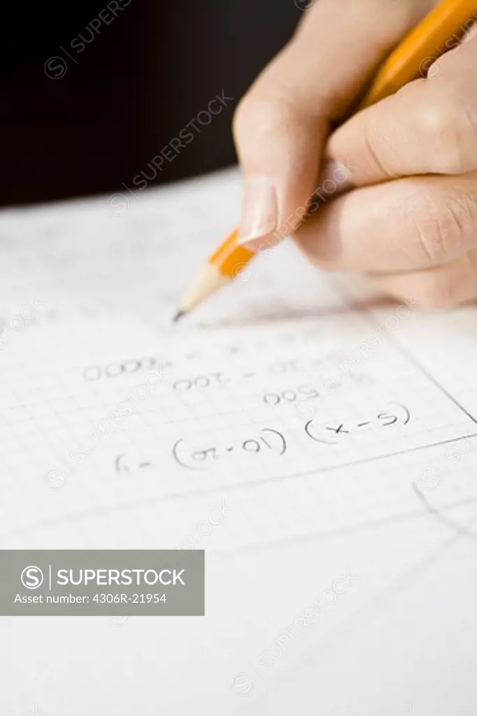 A woman working out a sum, close-up.