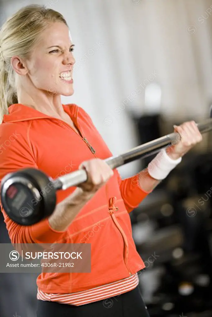 A woman weight training at a gym, Sweden.