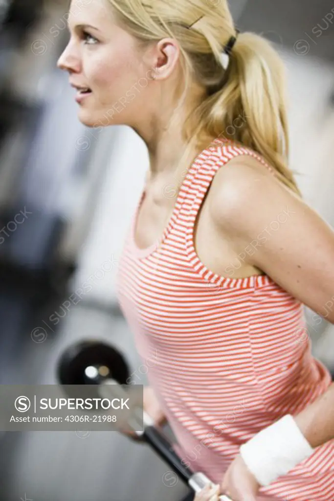 A woman weight training at a gym, Sweden.