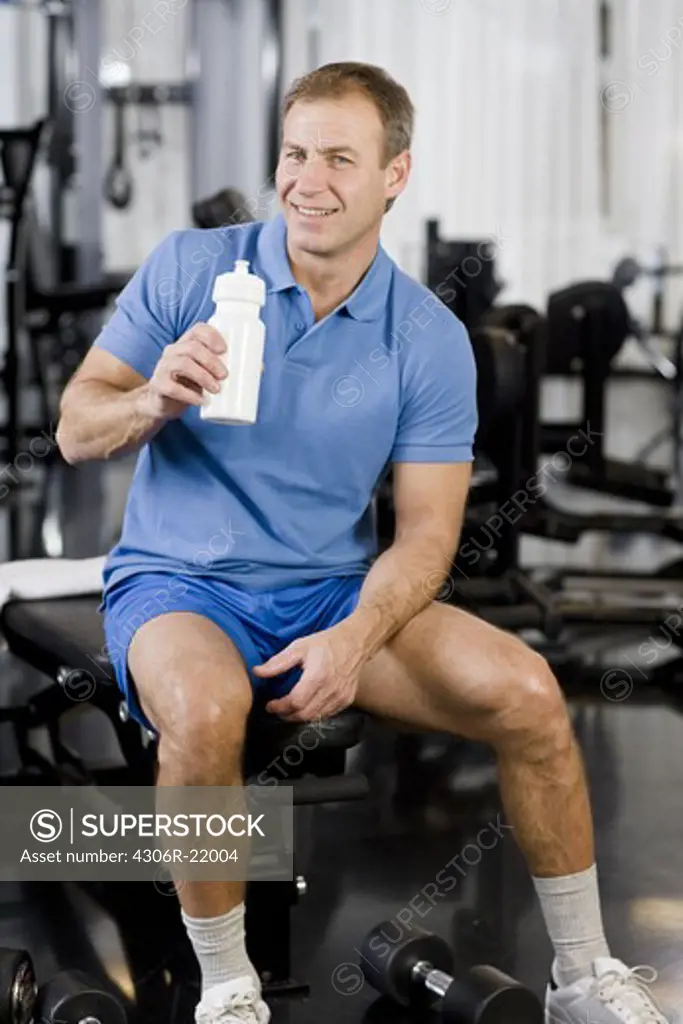A man weight training at a gym, Sweden.