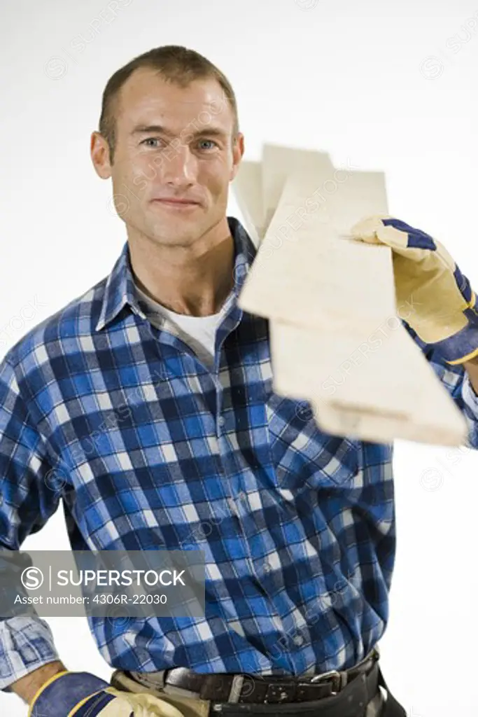 A craftsman carrying planks.