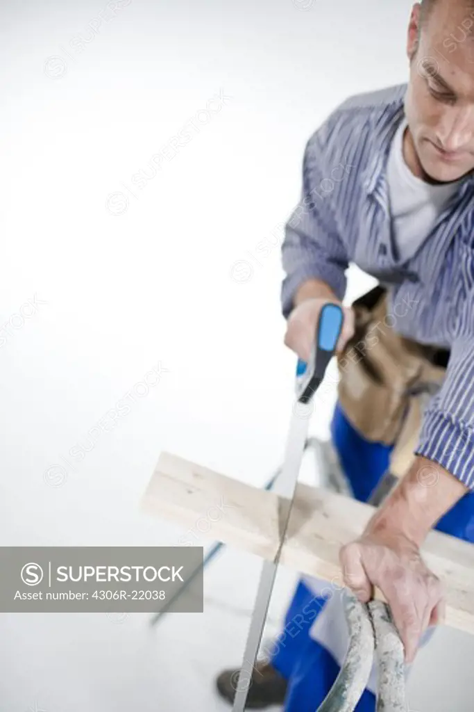 A joiner using a saw.