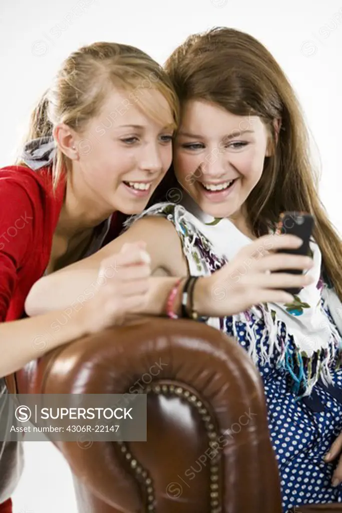 Teenage girls using a mobile phone.