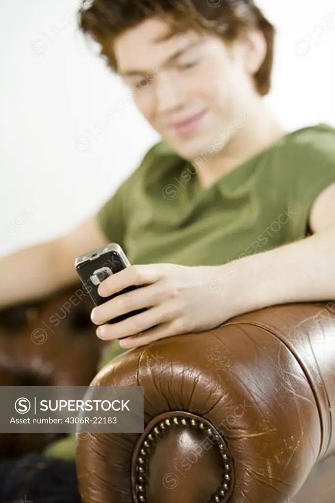 A teenage boy using a mobile phone.