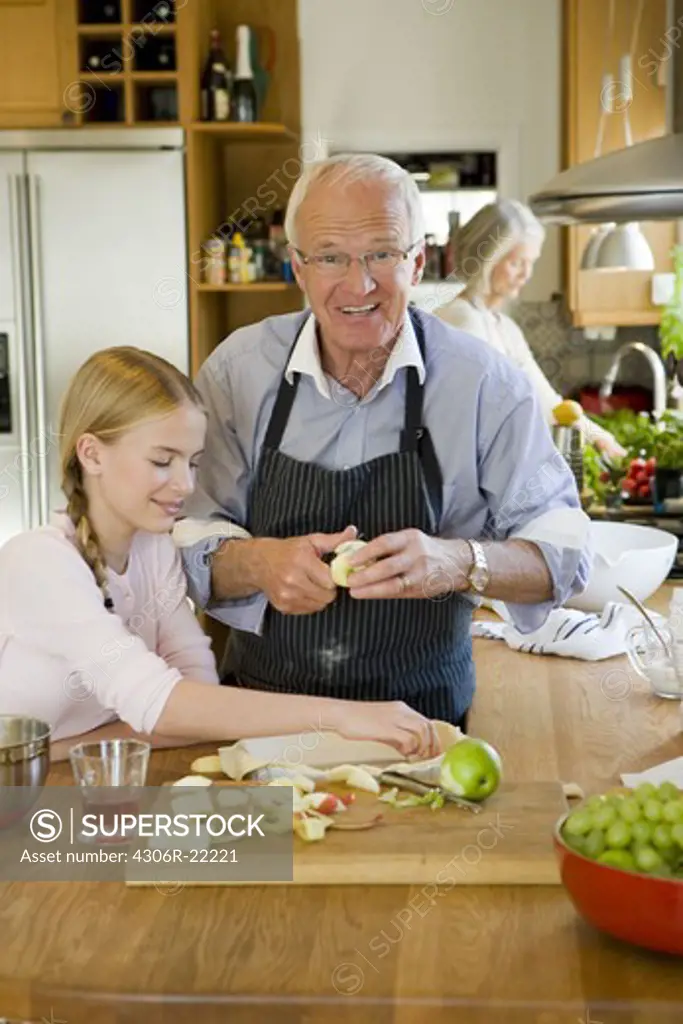 Senior couple baking with their granddaughter, Sweden.