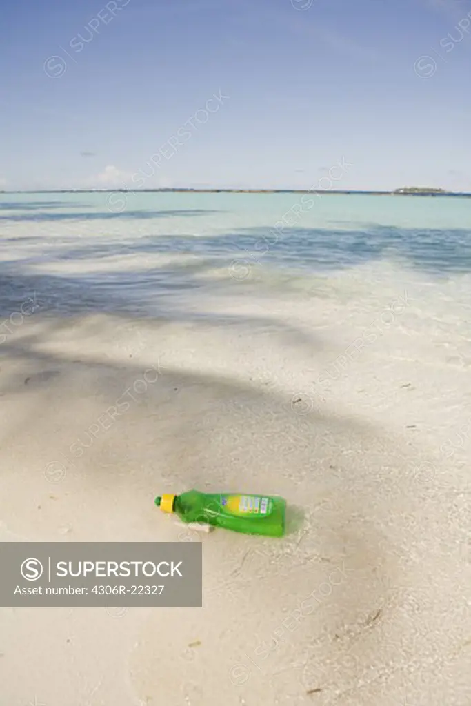 A plastic waste product on a sandy beach, the Maldives.