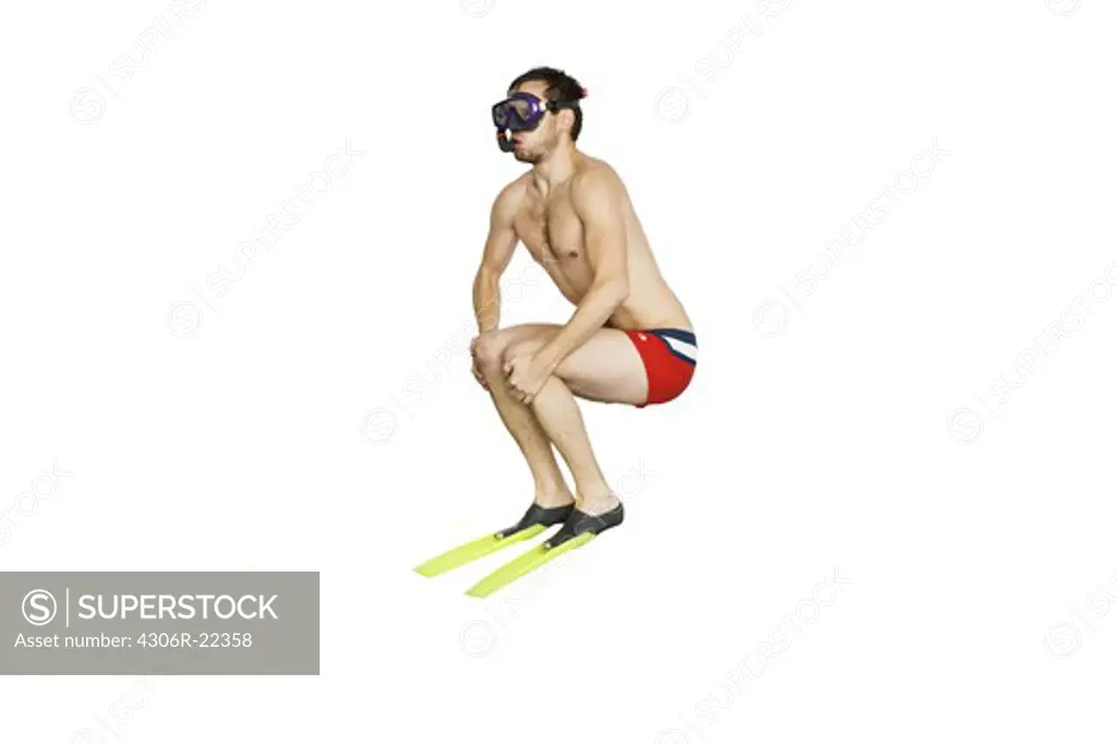 Young man with diving flippers and goggles.