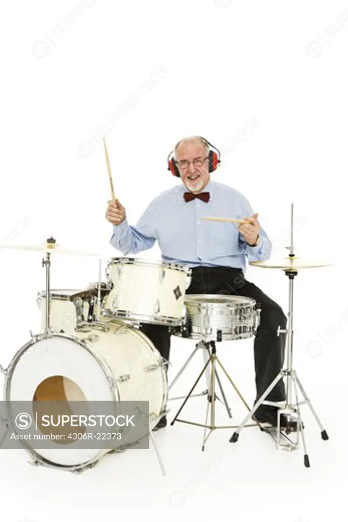 Senior man playing the drums.