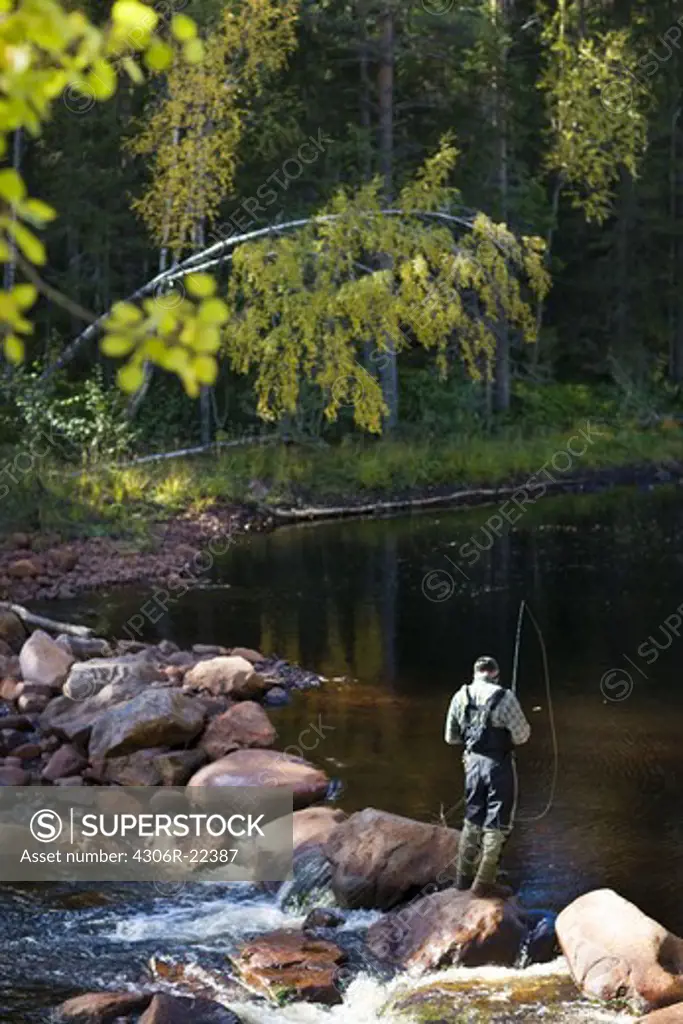A man fly-fishing, Sweden.