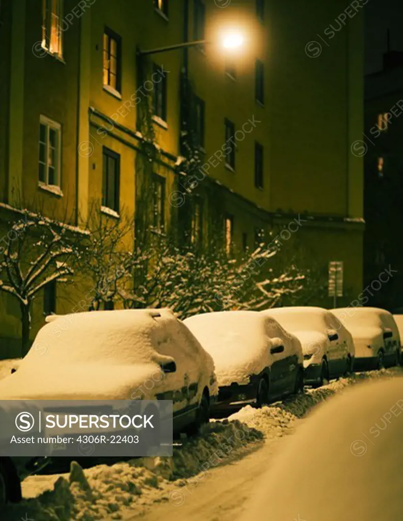 Snow-covered cars on a street, Sweden.