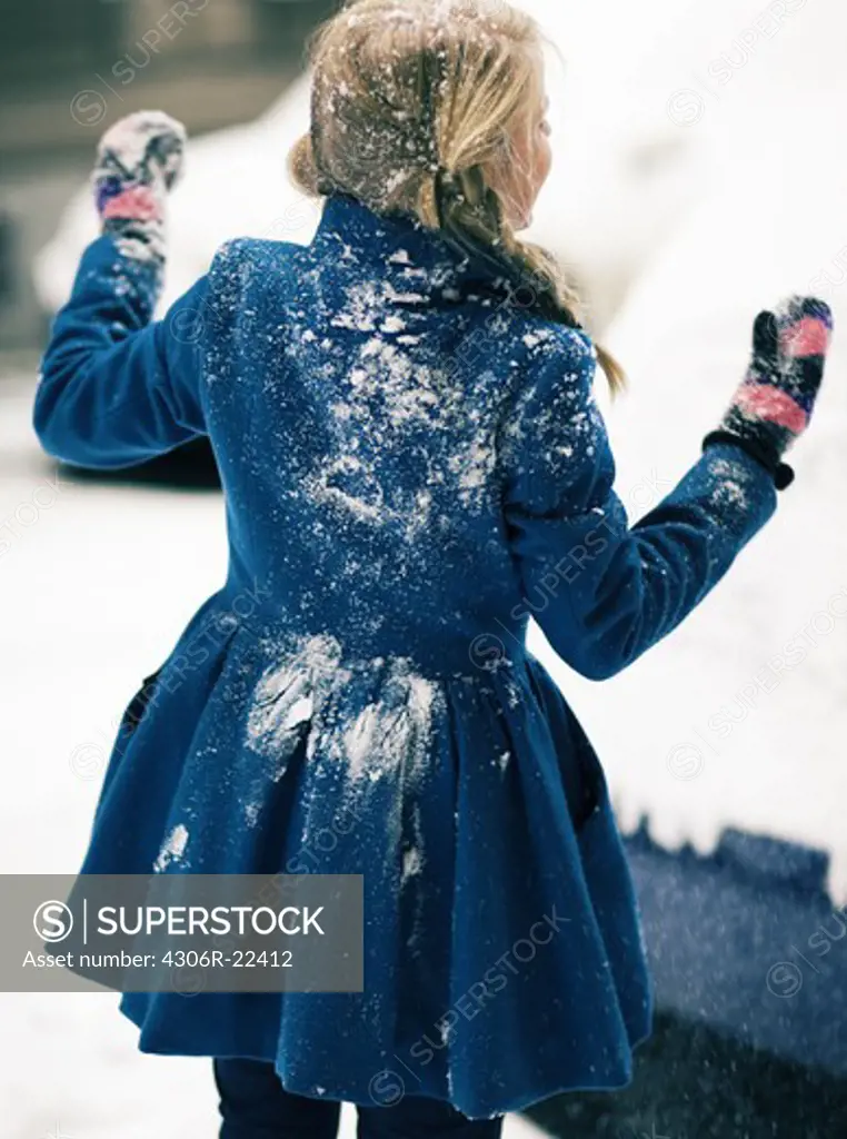 A teenage girl covered in snow, Sweden.
