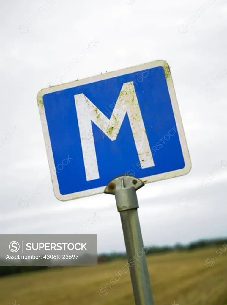 Close up of road sign with letter M