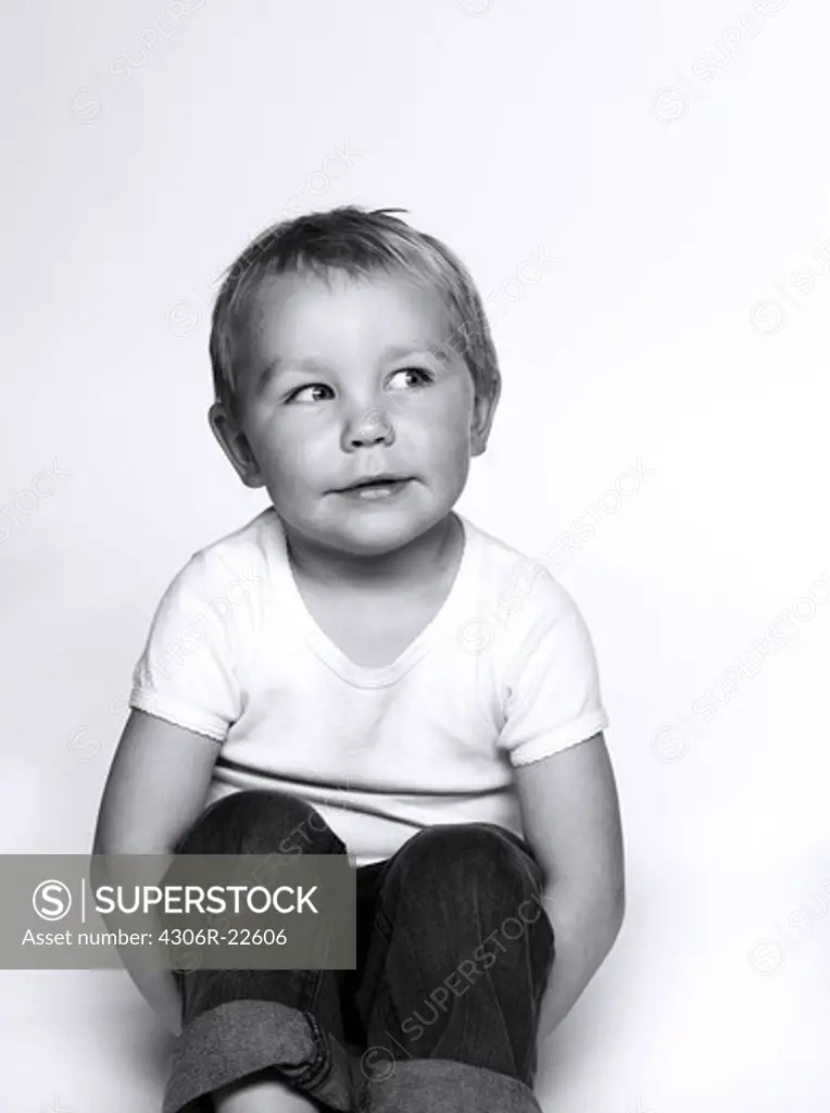 Portrait of boy sitting on floor