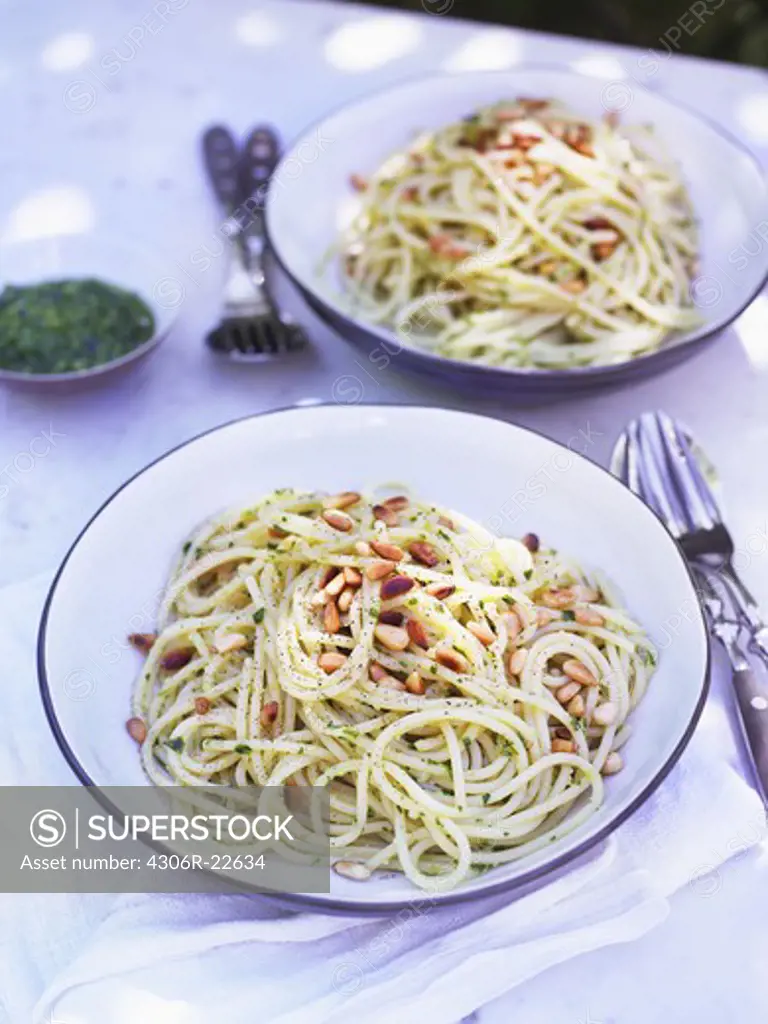 Spaghetti pasta with pesto sauce on plates