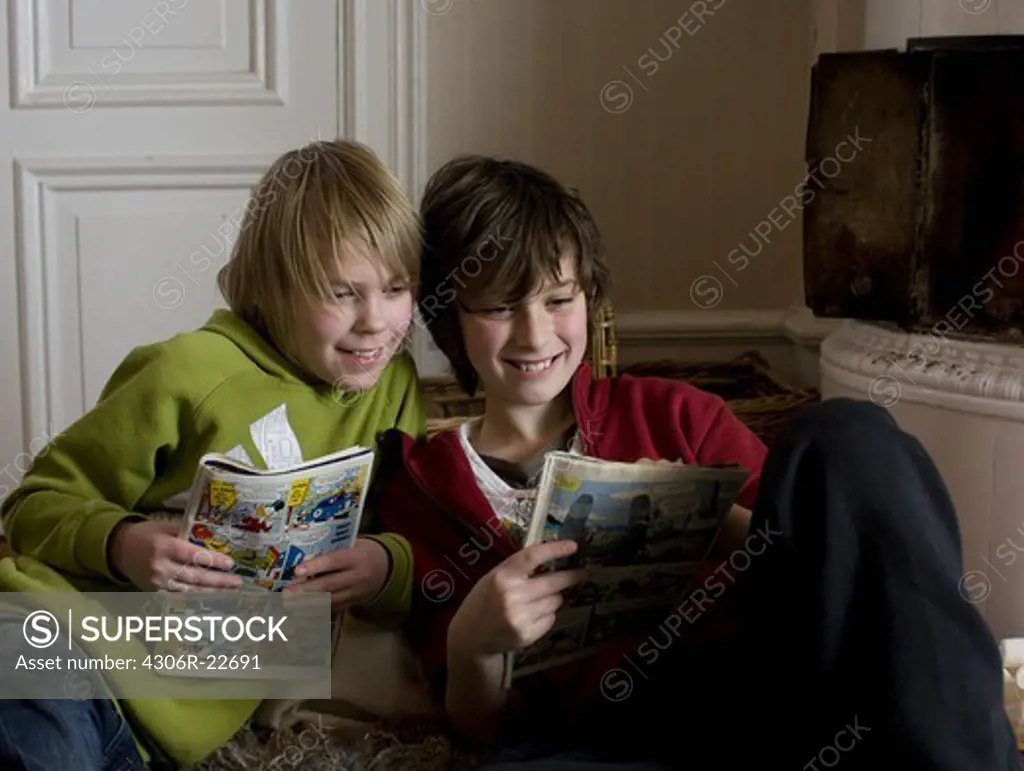 Two boys spending time in a living room, Sweden.