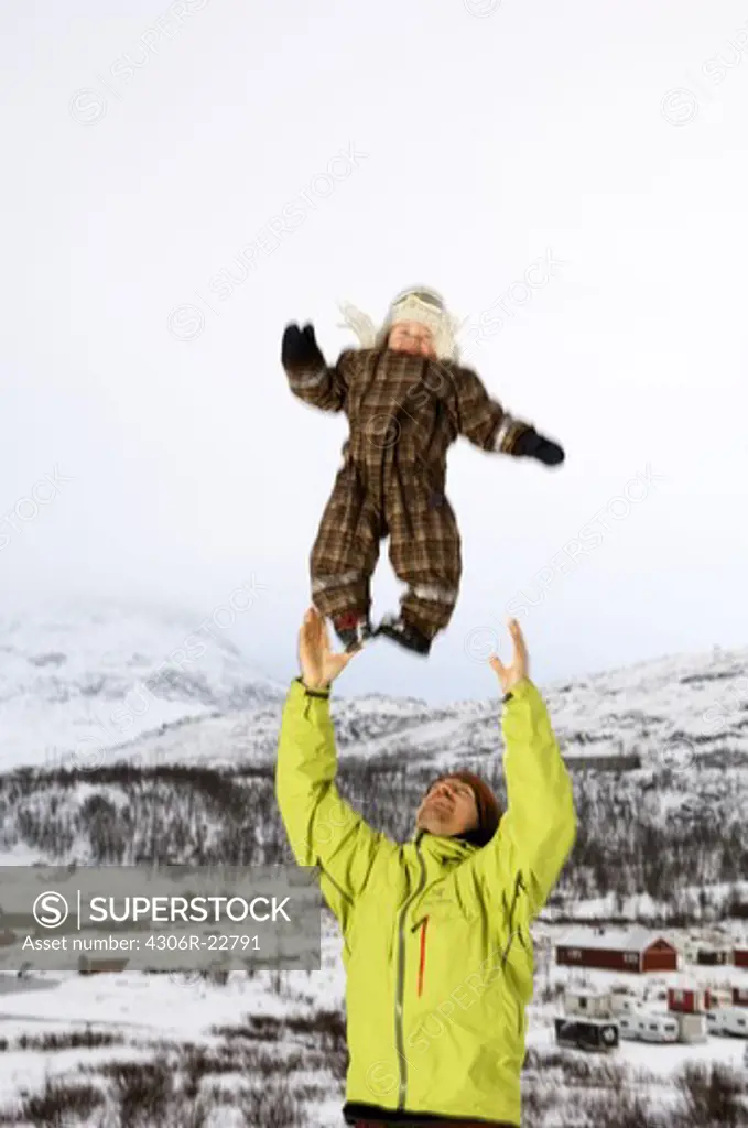 Father throwing up his baby in the air, Sweden.