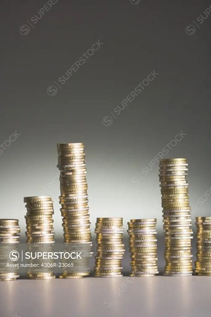 Euros piled up against a gray background.