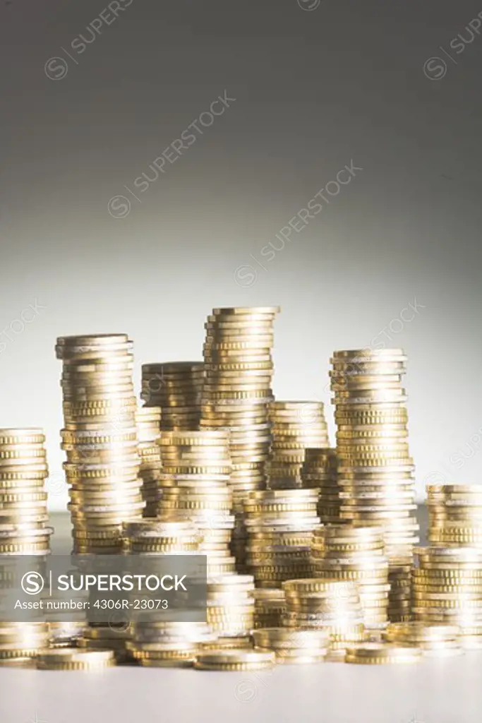 Euros piled up against a gray background.