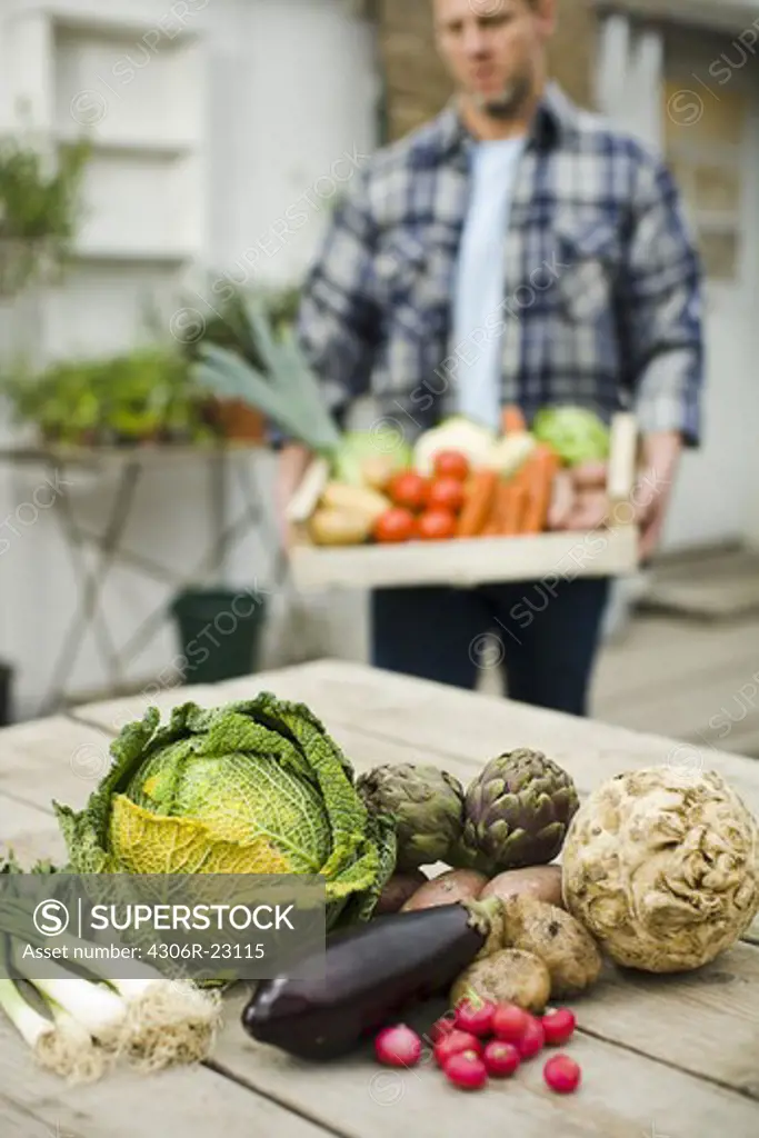 Farmer showing vegetables.
