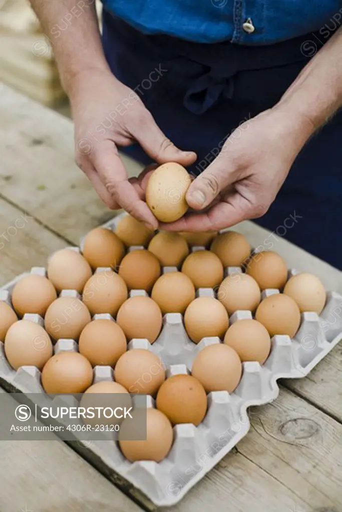 Farmer showing a box of eggs.